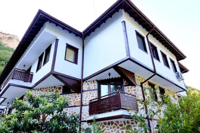 a building with balconies on the side of it at Хотел Свети Трифон in Melnik
