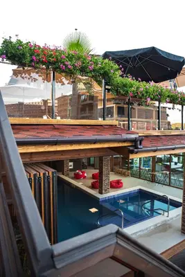 a rooftop garden with a swimming pool and flowers at Zarevata Guest House in Velingrad