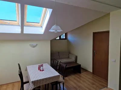 a dining room with a table and a window at Yastrebetz view in Borovets
