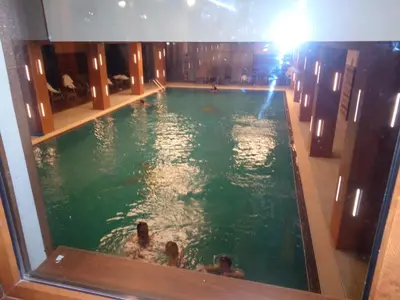 a swimming pool in a building with people in it at Yastrebetz view in Borovets
