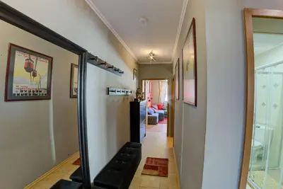 a hallway with a glass door leading to a living room at Gondola Flat Number 2 in Bansko