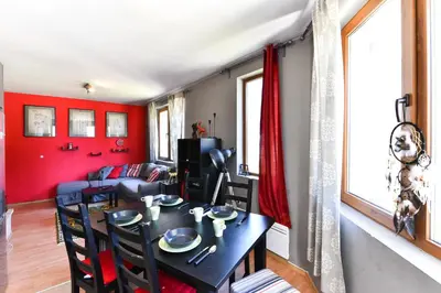 a dining room with red walls and a table and chairs at Gondola Flat Number 2 in Bansko