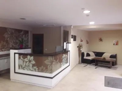 a living room with a fish tank and a couch at Pirin Heights in Bansko