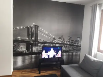 a living room with a tv with a bridge on the wall at Pirin Heights in Bansko