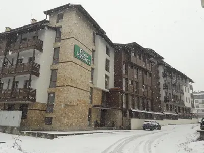 a building on a street in the snow at Pirin Heights in Bansko