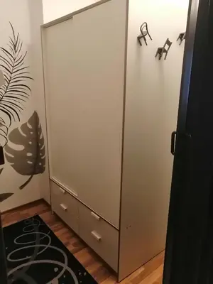 a large white cabinet in a room with a rug at Pirin Heights in Bansko