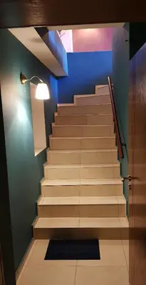 a staircase in a room with a blue wall at Studio Maison 3 Kapana in Plovdiv
