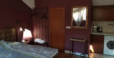 a bedroom with a bed and a washing machine at Studio Maison 3 Kapana in Plovdiv