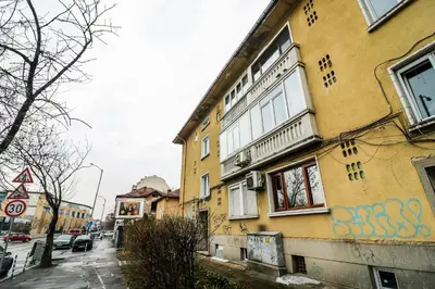 a yellow building with graffiti on the side of it at Lozenets Executive Apartment with Private Parking in Sofia