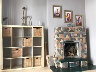 a living room with a fireplace and a book shelf at Han Krum 2 Bedroom Central Flat in Sofia