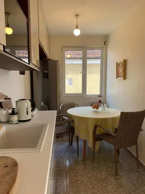 a kitchen with a table and chairs in a kitchen at Orient Express Guest House in Sofia