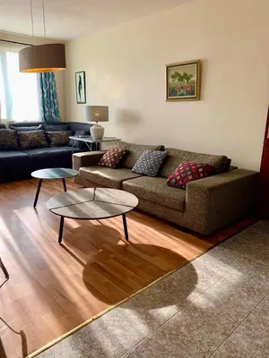 a living room with a couch and two tables at Orient Express Guest House in Sofia
