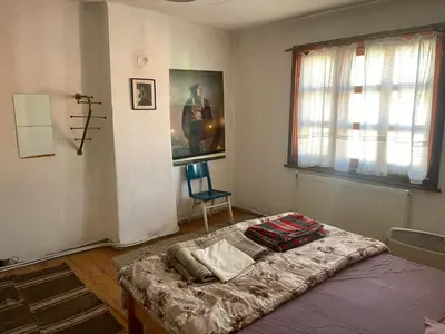 a bedroom with a bed and a chair in it at Das Landhaus in Bachevo