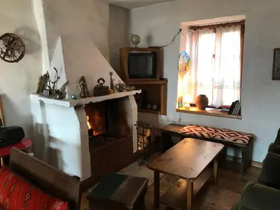 a living room with a fireplace and a tv at Das Landhaus in Bachevo