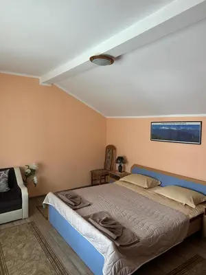 a bedroom with a blue bed in a room at Villa Paradise in Beli Iskar