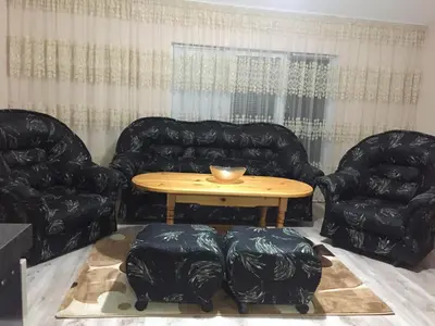a living room with two chairs and a table at Elenite Guesthouse in Gotse Delchev