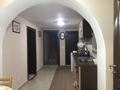 a kitchen with an archway leading into a hallway at Elenite Guesthouse in Gotse Delchev