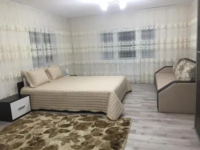 a bedroom with a large bed and a window at Elenite Guesthouse in Gotse Delchev