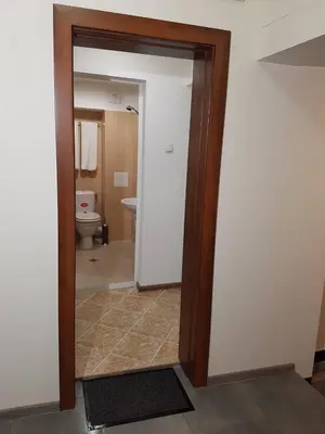 an open door to a bathroom with a toilet at Rooftop Oscar Rooms in Sofia