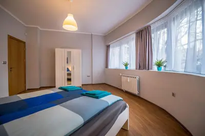 a bedroom with a large bed in a room with windows at 5th Avenue Sofia Two Bedroom, Two Bathroom, Positano Street Suite by Flat Mаnager in Sofia