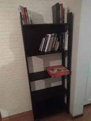 a black book shelf filled with books at 5th Avenue Sofia Two Bedroom, Two Bathroom, Positano Street Suite by Flat Mаnager in Sofia