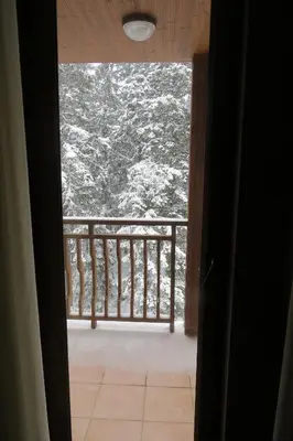 a view from a door of a balcony with a view at Snowdrop Studio in Borovets