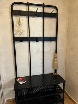 a black dresser with a mirror on top of it at Parchevich 31 Center Apartment - 24h Self Check-in in Sofia