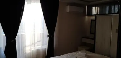 a bedroom with a bed and a window with curtains at Luxury Two Bedroom Flat in Blagoevgrad