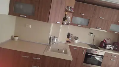 a kitchen with a sink and wooden cabinets at Luxury Two Bedroom Flat in Blagoevgrad
