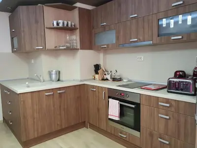 a kitchen with wooden cabinets and a stove at Luxury Two Bedroom Flat in Blagoevgrad