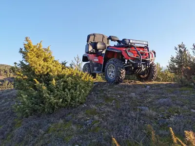 a red atv parked on the side of a hill at Banya Guest Rooms 23 in Banya