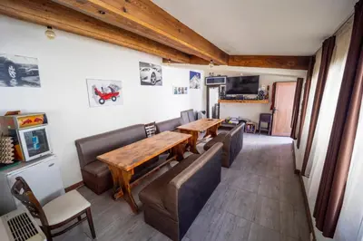 a living room with couches and a wooden table at Banya Guest Rooms 23 in Banya