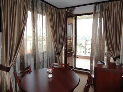 a dining room with a table and a large window at Favorit Hotel in Sofia