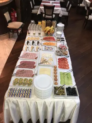 a table with many different types of food on it at Favorit Hotel in Sofia