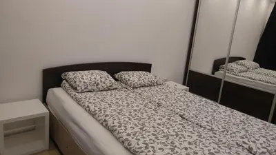a bed with two pillows on it in a room at Modern apartment Sofia center in Sofia