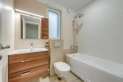 a bathroom with a toilet and a tub and a sink at Central Apartment in Sofia