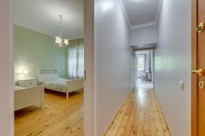 a hallway with a bedroom and a bed in a room at Central Apartment in Sofia