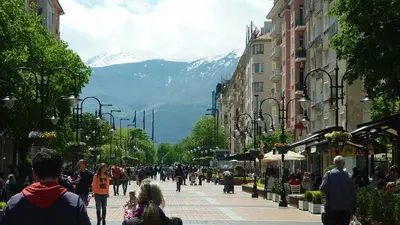 a crowd of people walking down a city street at Central Apartment in Sofia
