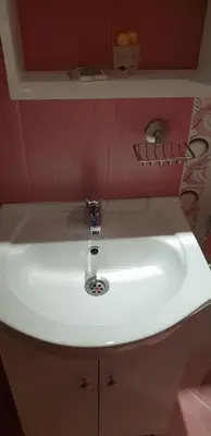 a white sink in a bathroom with a red wall at Cosy Apartment - City Centre in Blagoevgrad