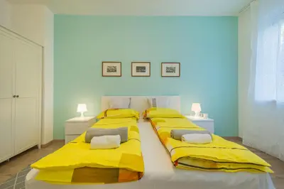 two beds in a room with yellow covers at CHIC and Spacious Apartment in Central Sofia - Patriarh Evtimiy by Flat Mаnager in Sofia