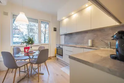 a kitchen with a table and chairs in a kitchen at CHIC and Spacious Apartment in Central Sofia - Patriarh Evtimiy by Flat Mаnager in Sofia