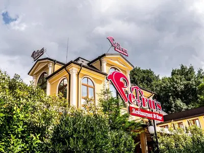 a fast food restaurant sign in front of a building at RENOVATED Boutique Apartments Petrus in Sofia