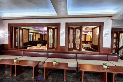 a lobby with two benches and a large mirror at Platinum Image Hotel in Elin Pelin
