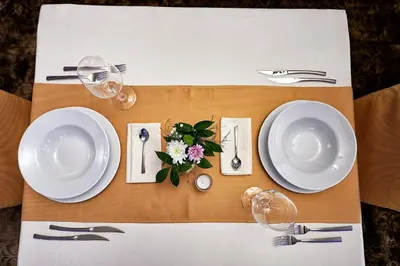 a table with white plates and silverware on a table at Platinum Image Hotel in Elin Pelin