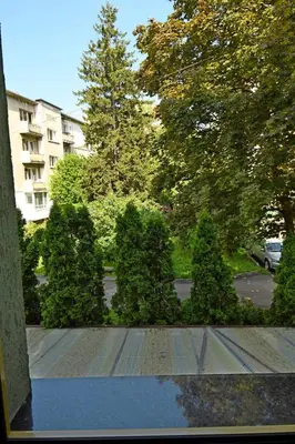 a view of a yard with trees and a building at Hotel Rai in Sofia