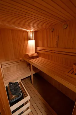 an inside of a sauna with a table and a lamp at Hotel Rai in Sofia