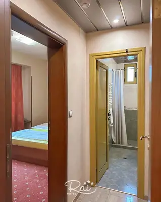 a door leading to a bedroom with a bed at Hotel Rai in Sofia