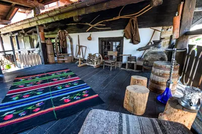 a room with colorful carpets on the floor of a building at Banskovilla Zlateva House in Bansko