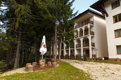 a building with a umbrella in front of it at Apartment Biliana in Pamporovo