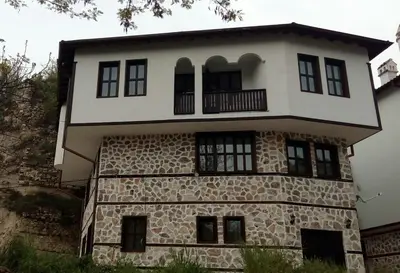 an old stone house with a balcony on top at Guesthouse White Margarit in Melnik